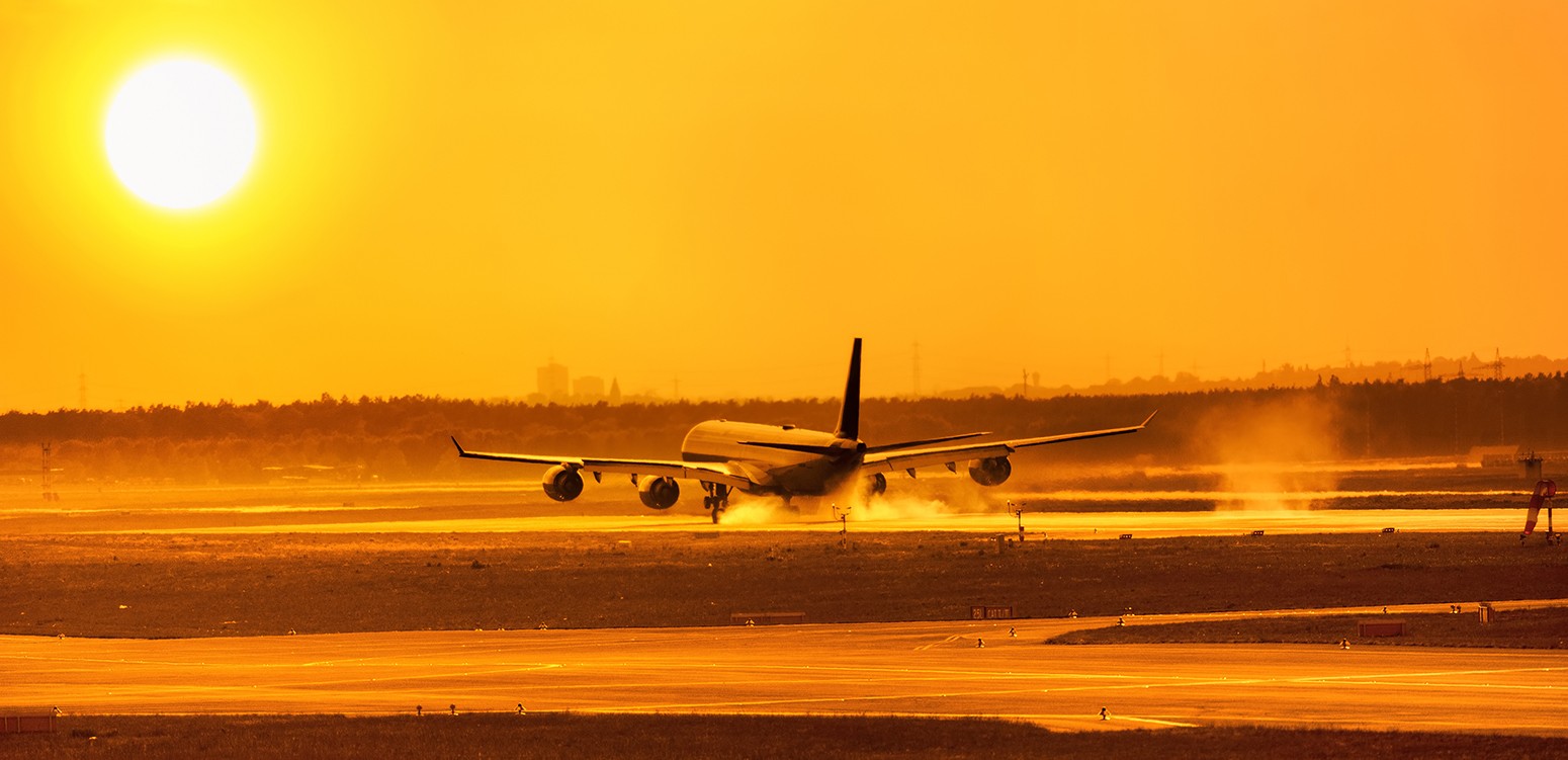 An airliner comes in to touchdown in the sunset