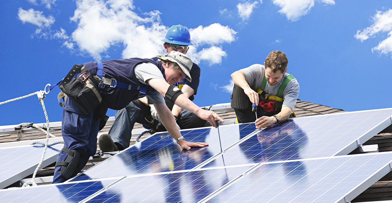 Workers installing solar panels