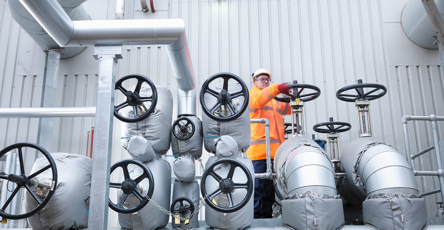 Worker turning valve of gas fired power station