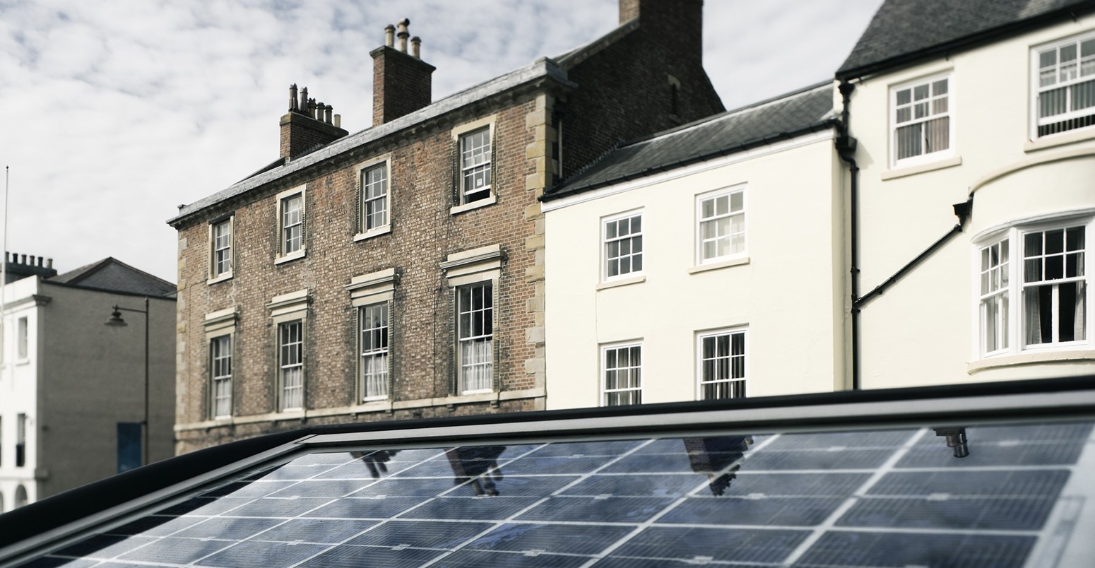 The solar panel of a parkmeter reflects the sky in a street of Durham, England.