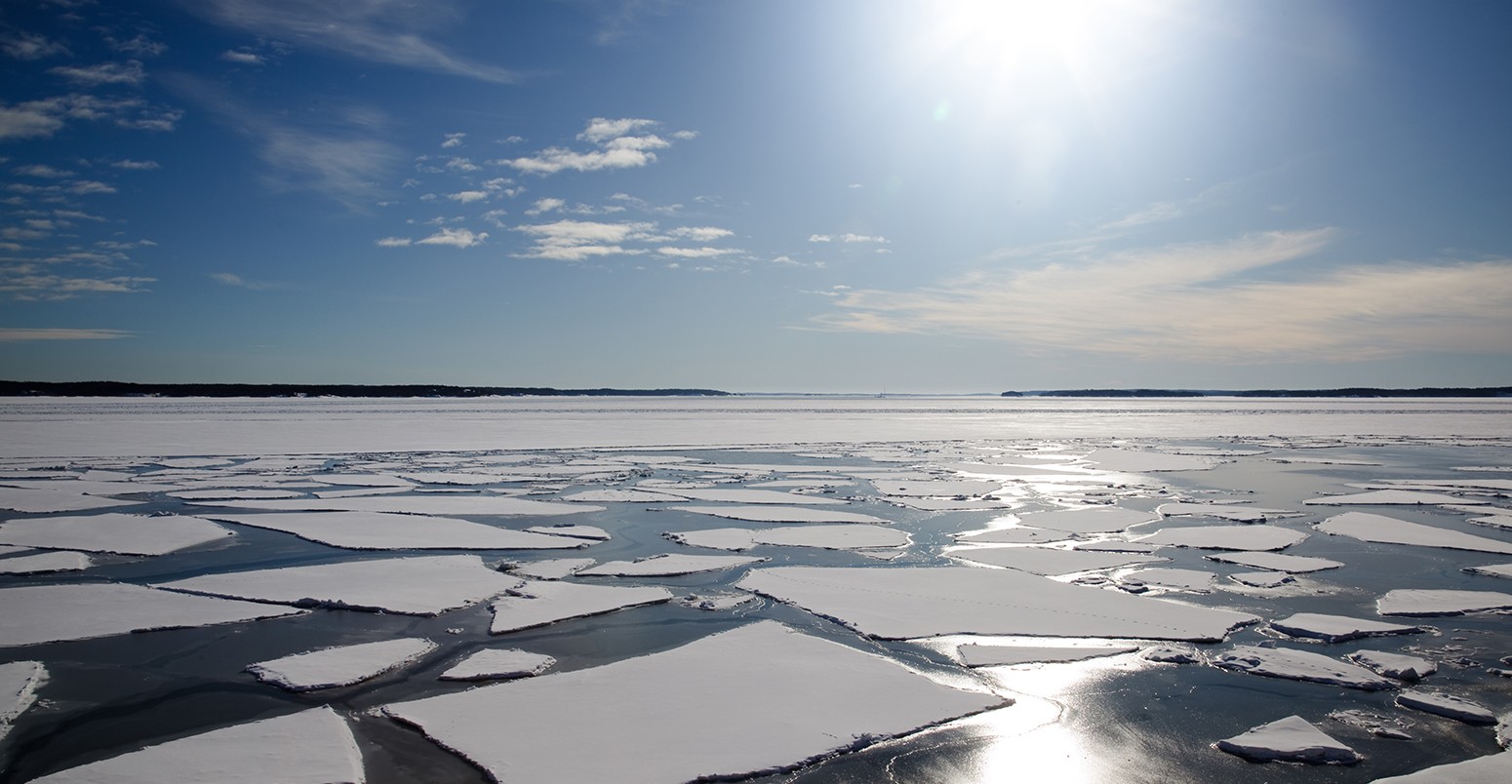 Arctic landscape in the sunlight with packed ice in the sea.