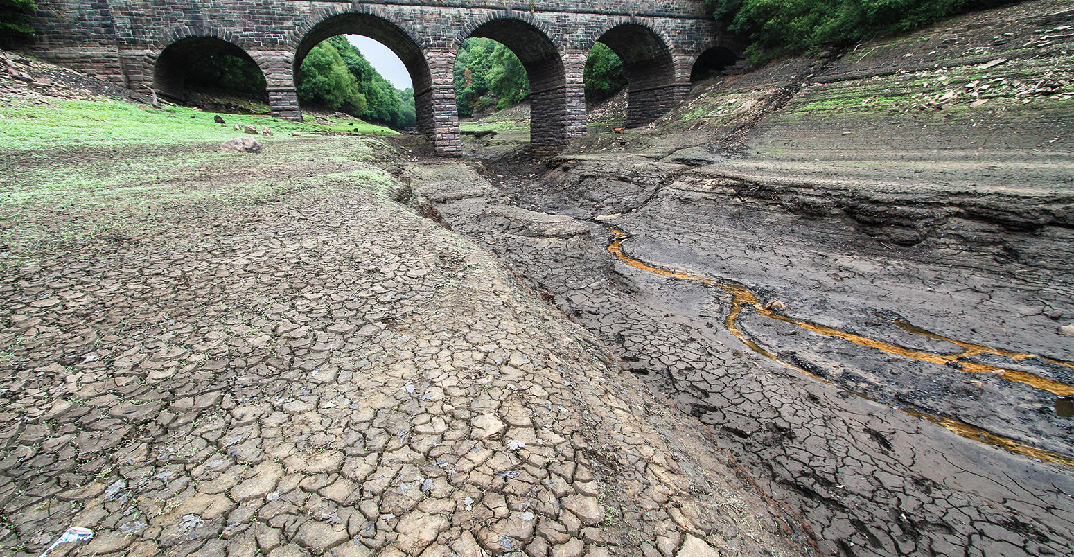 PAGGF2 Lancashire, UK. 21 July 2018. The Reservoir is now showing very low levels due to a sustained dry period, and is shown here after 2 days of rain. United Utilities who own the reservoir intend to introduce a hosepipe ban from 5 August 2018. The reservoir supplies Liverpool via a series of reservoirs in the Rivington area, which were recently used to supply water for helicopters fighting the Winter Hill fires. The bridge shown is the Alance Bridge, which spans the River Yarrow, which would normally flow through it into the reservoir. Credit: Phil Taylor/Alamy Live News