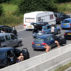 People stuck in a traffic jam in Somerset, UK, leave their cars during a heatwave on 30 July 2016. Credit: Timothy Large / Alamy Stock Photo. GFAT52