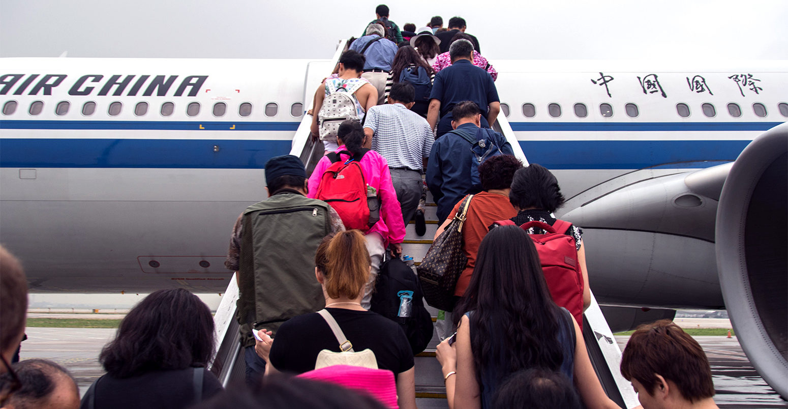 Passengers boarding an Air China plane at the Beijing Airport. Credit: Edwin Remsberg / Alamy Stock Photo.