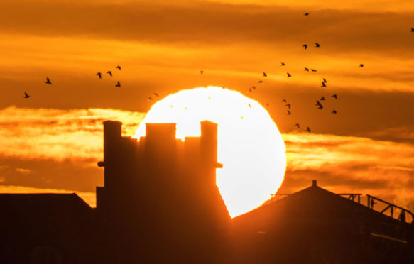 Unseasonably warm weather as the morning sun rises over the historic landmarks along the promenade in Southport on Merseyside, UK. 2 January 2020. Credit: KeyWorded / Alamy Stock Photo