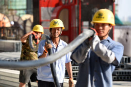 Chinese migrant workers of CREC labor at the construction site of the Huai'an East Railway Station for high-speed railway.