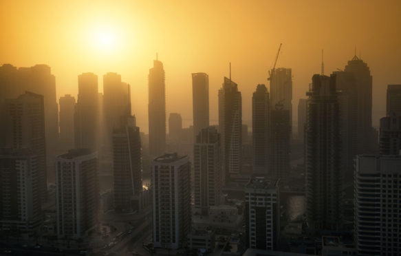 Dubai Marina skyscrapers at sunset with heat haze. May 2017. Andrew Deer / Alamy Stock Photo