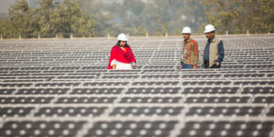 Workers-at-a-1MW-solar-power-station-run-by-Tata-Power-on-the-roof-of-an-electricity-company-in-Delhi,-India