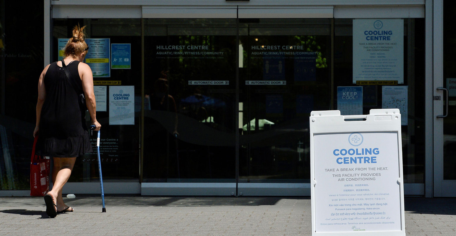 A woman enters a cooling centre during the scorching weather of a heatwave in Vancouver