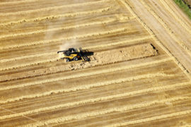 An aerial view of farm machinery in the field harvesting wheat Idaho_EN9MDW