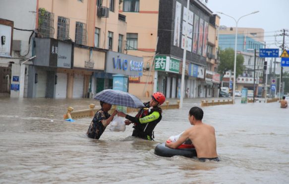 Firefighters help citizens with their vehicles and safety as Typhoon In-fa brings heavy rains and flooding in Ningbo City_2GA6GHR