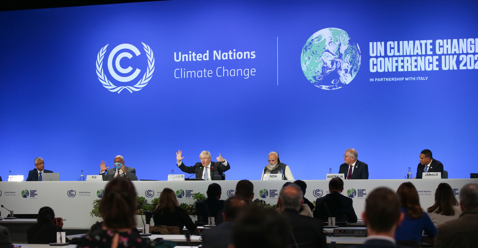 Boris Johnson makes the 1.5 degree hand gesture at COP26