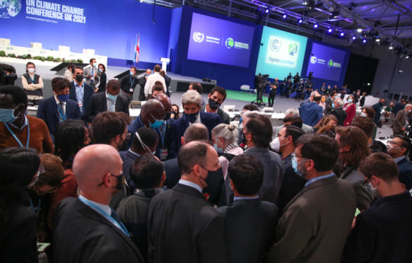 Delegates huddle at closing Plenary of COP26