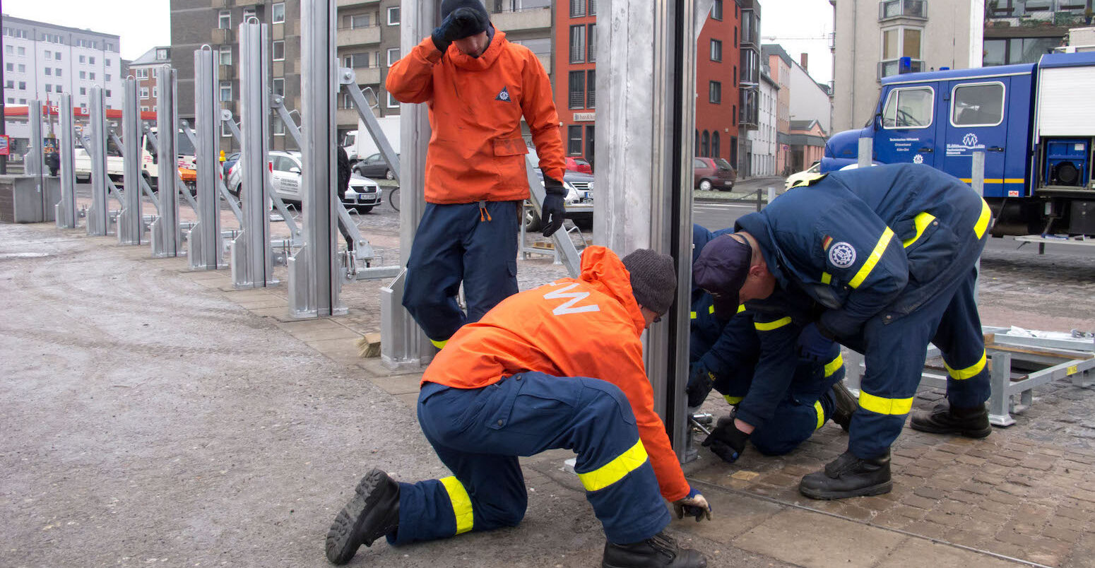 Installing flood defence barriers beside River Rheine in central Cologne, Germany.