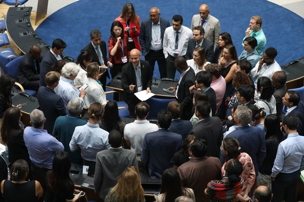 Delegates huddle as discussions on the GST continue.