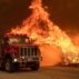 A Los Angeles County fire truck attacks flames in Valyermo, California.