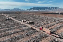 Workers speed up installation of photovoltaic panels at the construction site of the solar power generation project in Zhangye, China.