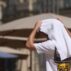 A person covers themselves with a towel as temperatures reach 38C in Montpellier, France on 19 July 2023.