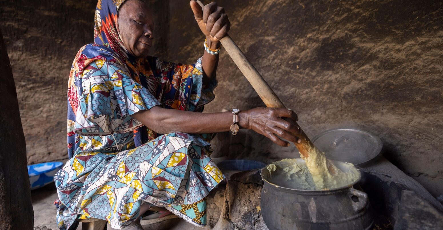 A woman cooking over a fire in Mali, West Africa.