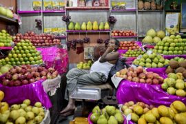 A fruit seller sleeps in his fruit shop in Kolkata, India.