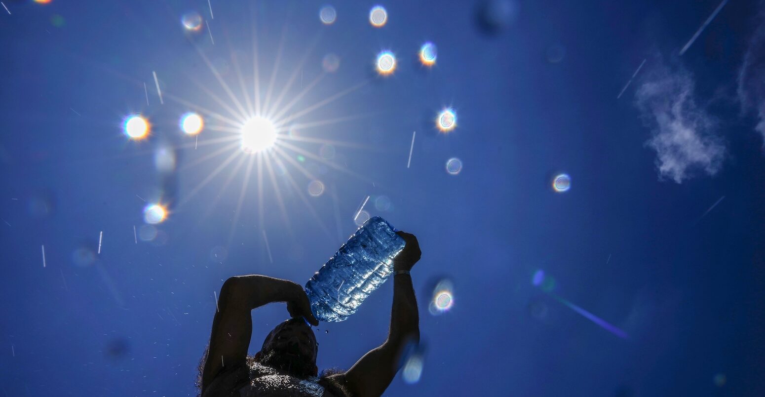 A man pours cold water on himself to cool off in Beirut, Lebanon.