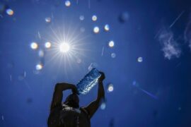 A man pours cold water on himself to cool off in Beirut, Lebanon.