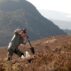 Man plants a tree in Abernethy Forest, Scotland.