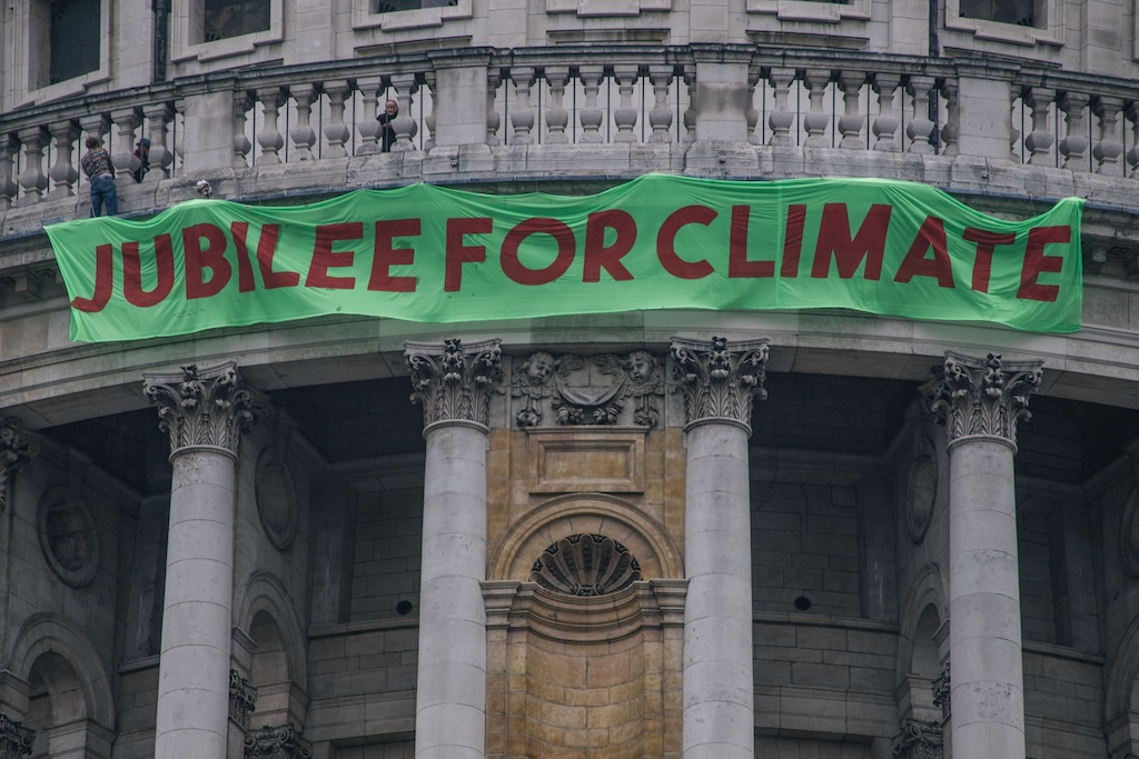 Activists draped a banner over St Paul’s Cathedral calling for a debt “jubilee” for climate on the tenth anniversary of Occupy London. 