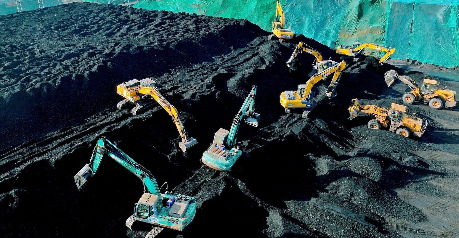 Excavators build a heap of coal in Jiangsu Province, China.