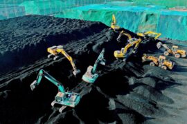 Excavators build a heap of coal in Jiangsu Province, China.