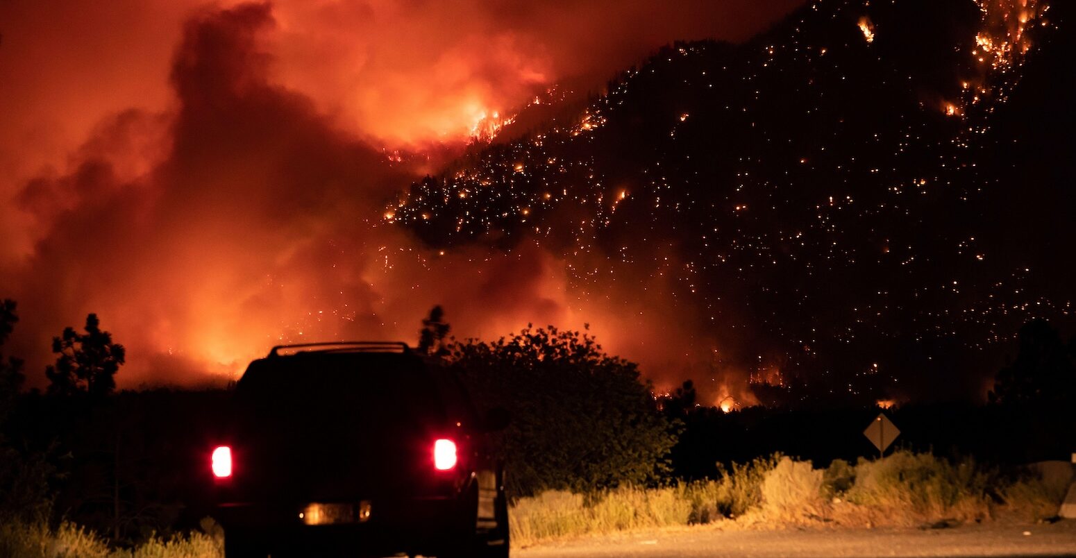 A wildfire burns on the side of the Trans-Canada Highway in British Columbia, Canada.