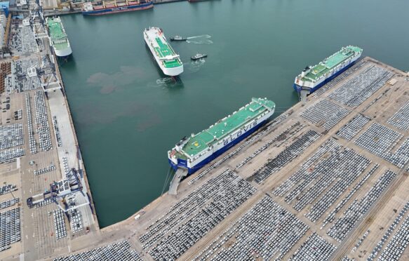 Car carriers load cars for export at Yantai Port, Shandong province, China.