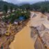 Rescuers cross a river in Kerala state, India after a landslide on 31 July 2024.