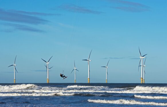 Offshore windfarm and kite surfer in Yorkshire, UK.