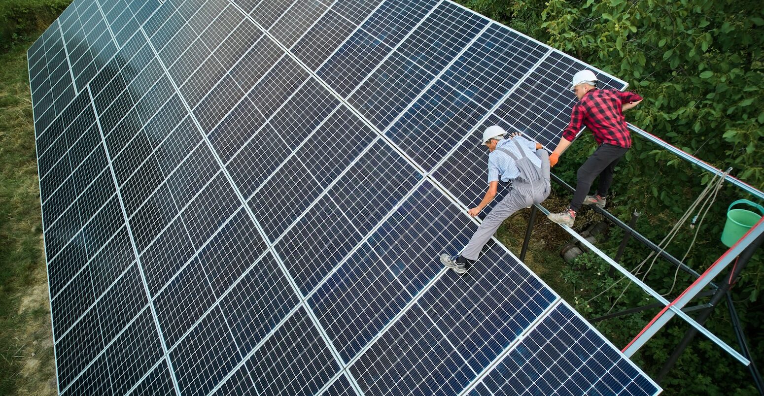 Aerial view of technicians installing solar panels.