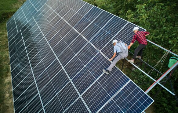 Aerial view of technicians installing solar panels.