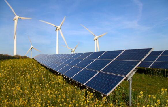 Solar panels and wind turbines in a field