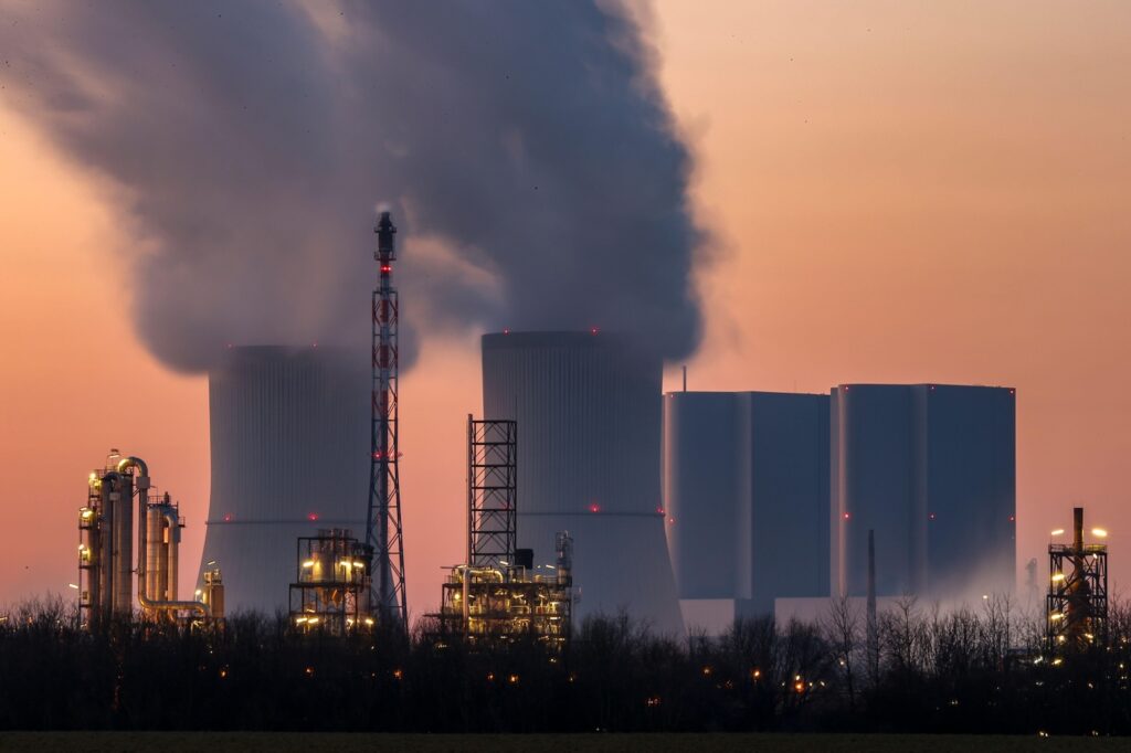 Steam flows out of various parts of Dow Chemical's plants, with the Lippendorf power plant in the background. 