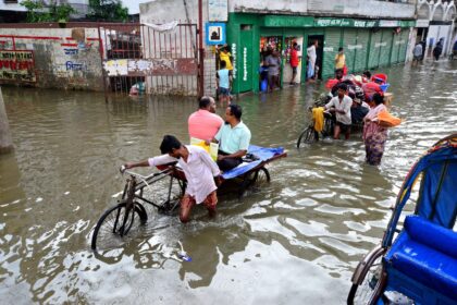 Rickshaws struggle through the flooded streets of Dhaka, Bangladesh.