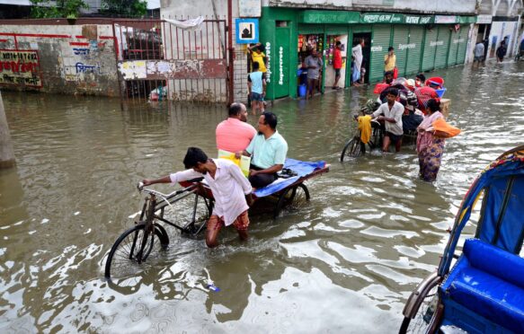 Rickshaws struggle through the flooded streets of Dhaka, Bangladesh.