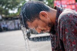 A man bends over during a summer heatwave in Bangladesh.