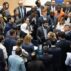 Delegates huddle during consultations on Paris Agreement Article 6.8.