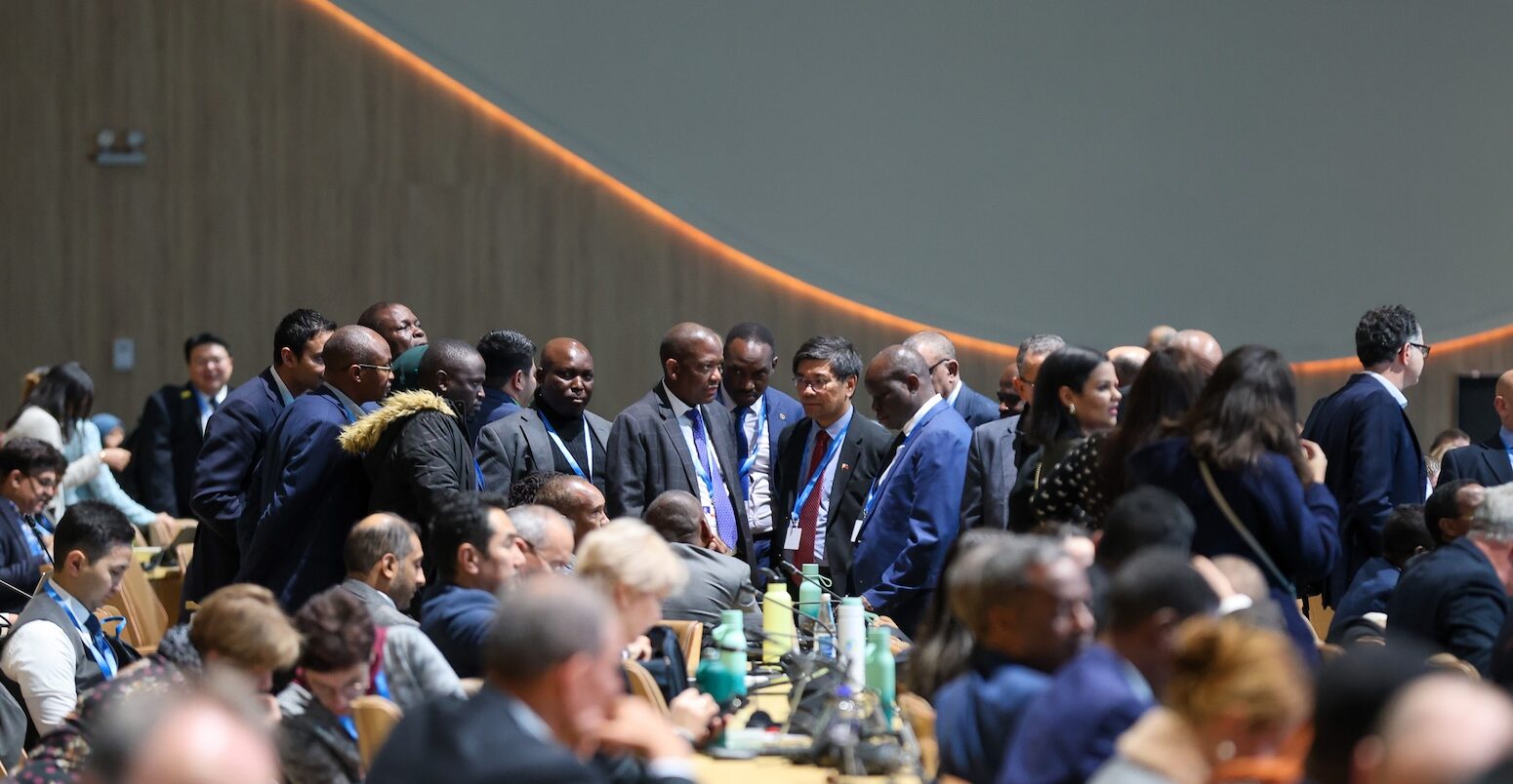 Delegates huddle at COP29 in Baku.