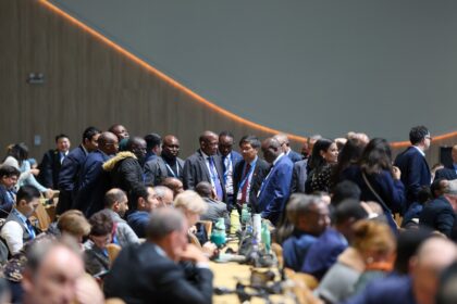 Delegates huddle at COP29 in Baku.