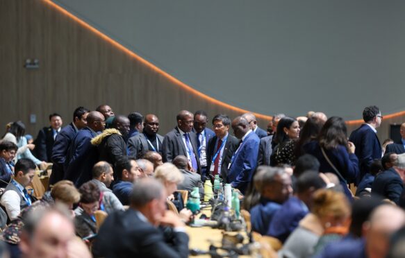 Delegates huddle at COP29 in Baku.