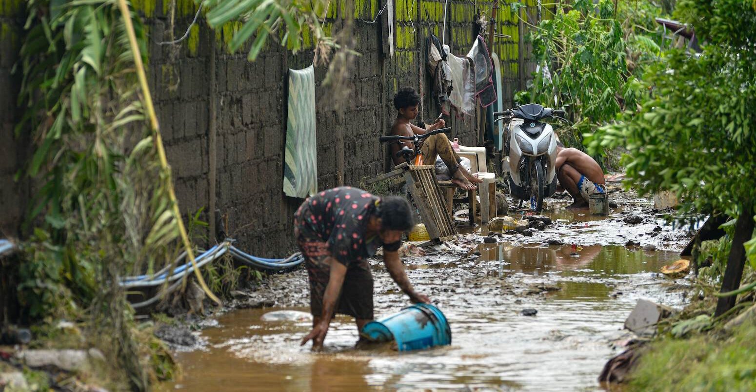 Residents cleaning the mud after tropical storm Kristine flooded Lemery, Philippines, 25 October 2024. Credit: ZUMA Press, Inc. / Alamy Stock Photo. Image ID: 2YD4WRX.