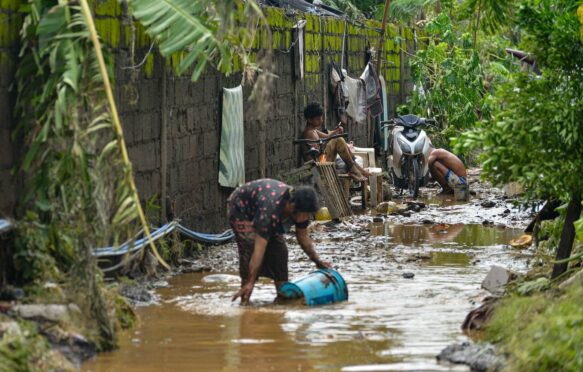 Residents cleaning the mud after tropical storm Kristine flooded Lemery, Philippines, 25 October 2024. Credit: ZUMA Press, Inc. / Alamy Stock Photo. Image ID: 2YD4WRX.