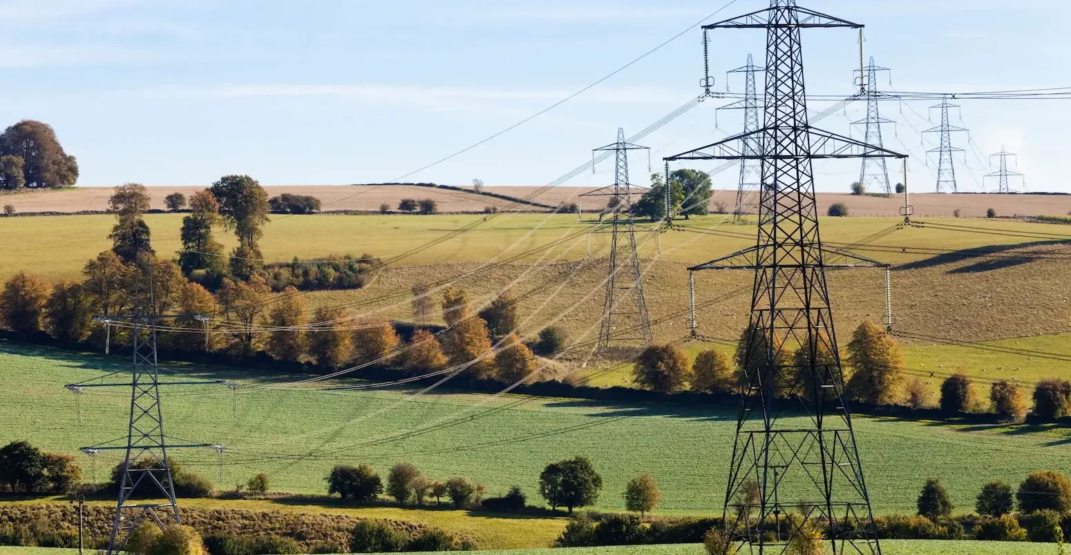 Pylons striding across the Cotswold countryside near Gloucestershire.