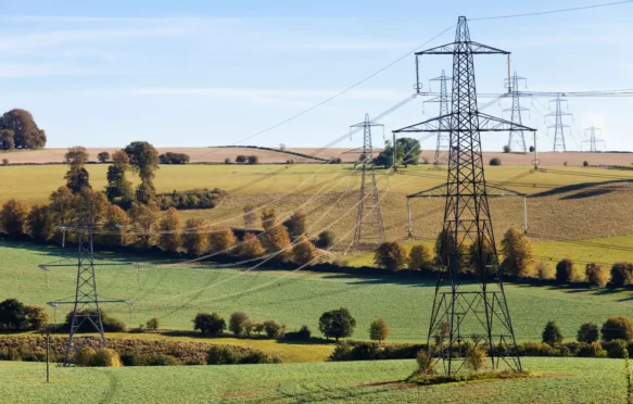 Pylons striding across the Cotswold countryside near Gloucestershire.