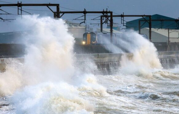 Storm winds of up to 60 mph creating high waves lashing over Saltcoats promenade, UK December 2024.